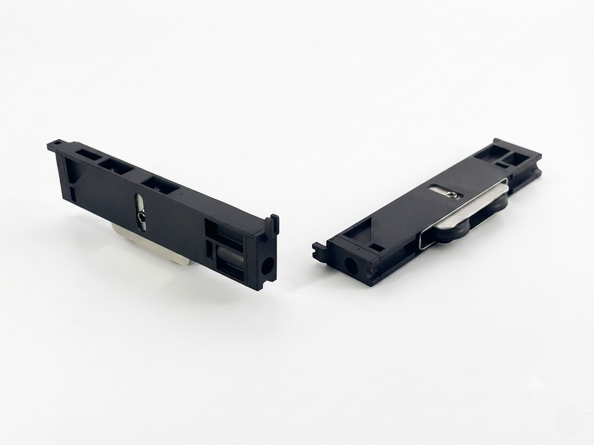 Injection-molded roller bracket pair with mounting slots