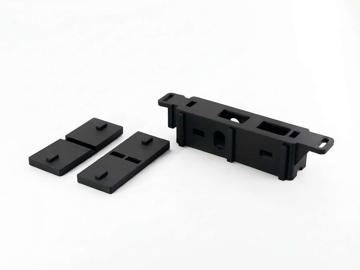 Injection-molded roller bracket and wheel housing set