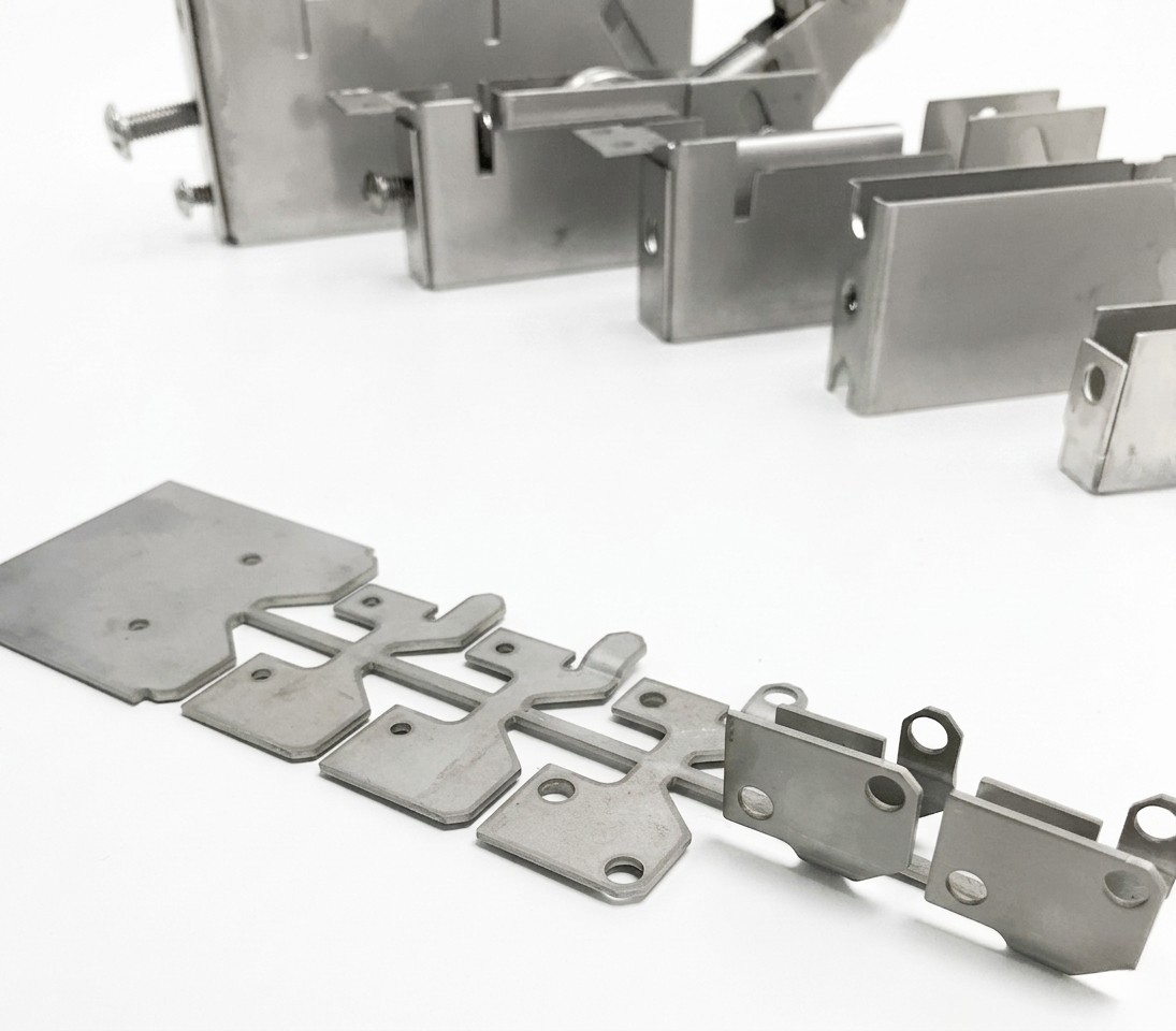 Progressive die stamping carrier strip with formed parts