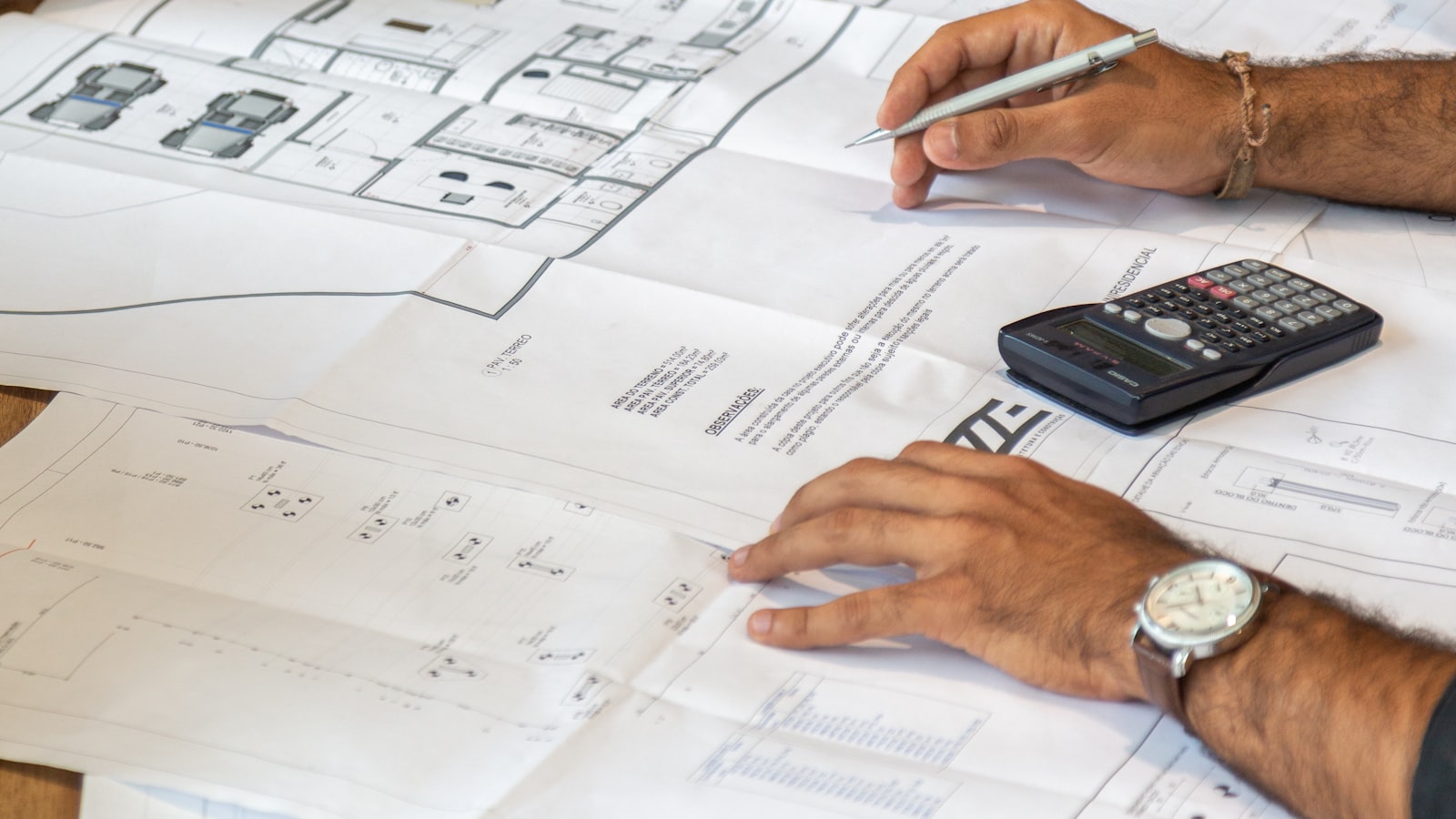 Engineering team reviewing technical drawings